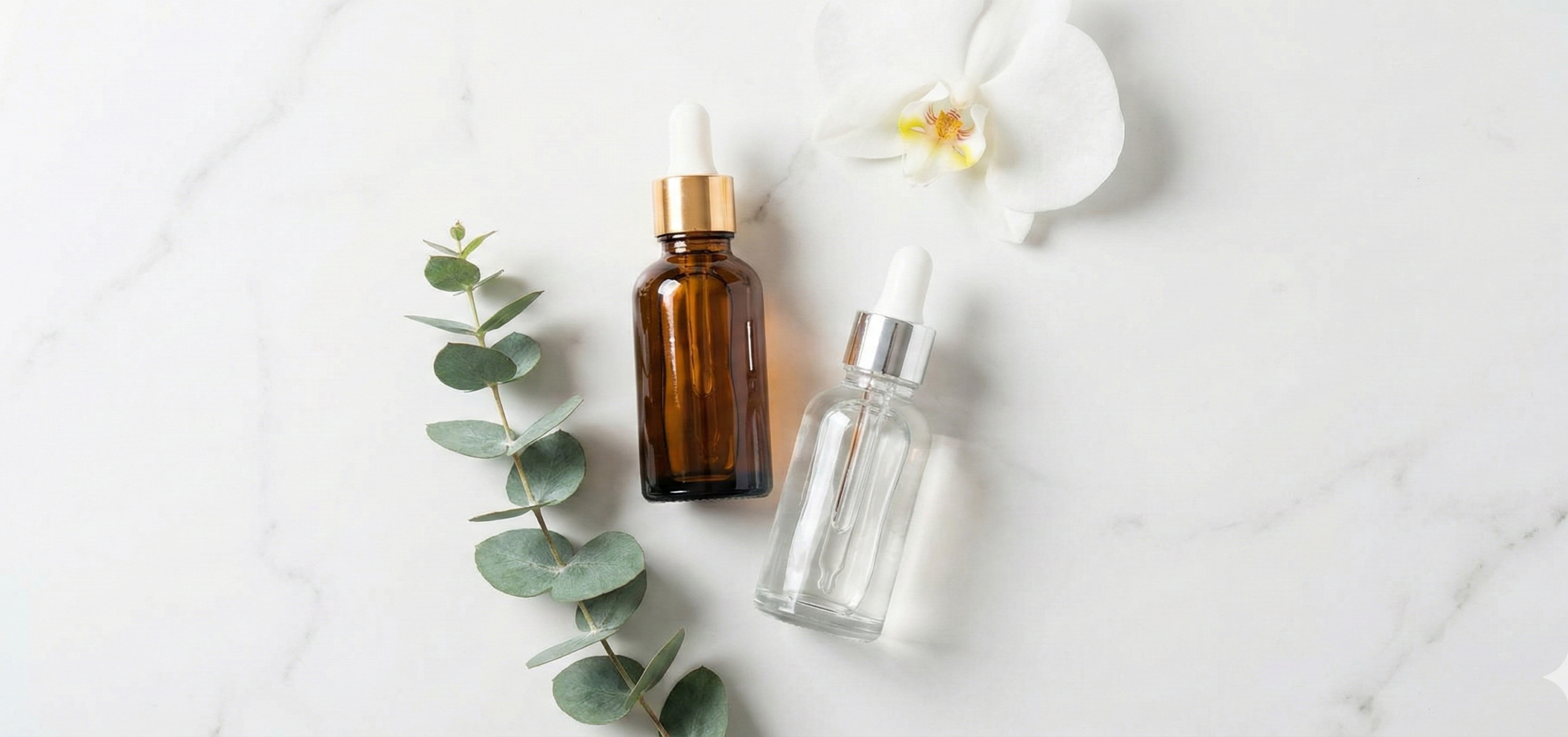 serum bottles and a green leaf or white flower